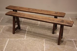 A pair of oak benches or forms, 19th century, each with a plank top upon splayed legs of square