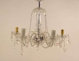 A cut glass chandelier, 20th century, the domed top leading to five scrolling arms, suspending cut