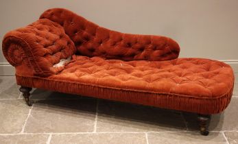 A Victorian walnut and red velour chaise longue, with a button down scroll end and seat, upon beaded