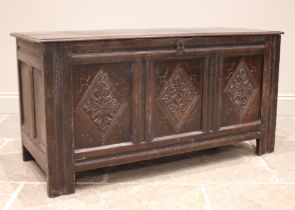 An 18th century oak coffer, the moulded two plank top with carved serrated banding, opening to a