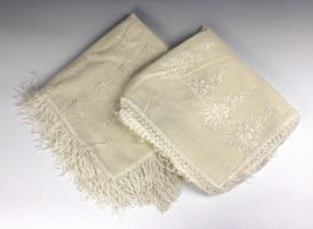 A cream wool shawl, with stylised floral embroidery to one end only, fringed all round, 126cm