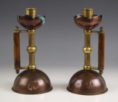 A pair of Arts & Crafts style copper and brass chamber sticks in the manner of Christopher
