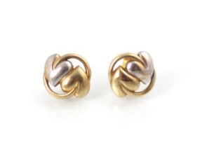 A pair of two tone 9ct gold earrings, the circular studs with continuous two leaf decoration, with