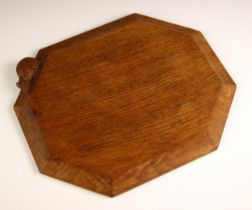 Workshop of Robert 'Mouseman' Thompson of Kilburn, a carved oak bread or cheese board, of canted