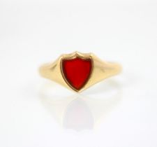 An early 20th century carnelian set signet ring, the shield shaped carnelian within yellow gold