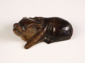 A Chinese carved stone model of a buffalo, of mutton fat jade colour, 7cm wide