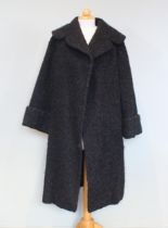 A 1950s black poodle cloth coat with large collar, turn back cuffs, edge to edge with patterned