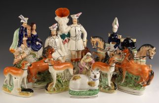 A selection of 19th century and later Staffordshire Pottery models, to include: a woman reading to a