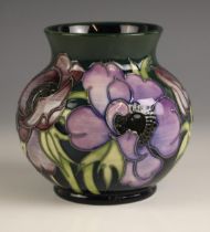 A Moorcroft ‘Anemone’ vase, of squat form, the body tube lined with a floral spray to a dark green