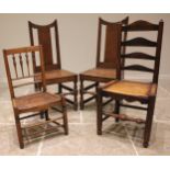 A pair of 18th century oak hall chairs, each with a splat back over a board seat upon baluster and