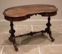 A Victorian figured walnut kidney shaped writing desk, the skiver inset moulded top with a three