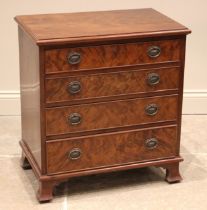 A mahogany bachelors chest of drawers, 19th century and later, the flame mahogany top over four cock