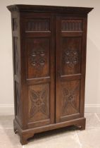 A 17th century revival oak hall cupboard, late 19th/early 20th century, the carved cornice over a