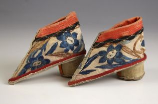 A pair of Chinese silk embroidered shoes, 19th century, each of stilt form and embroidered to the