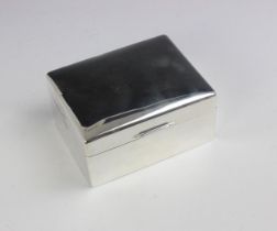 A silver cigarette box, Walker and Hall, Sheffield 1960, the rectangular hinged cover above