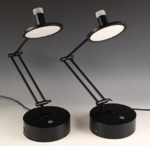 A pair of Heals of London table lamps, each with adjustable arm, upon circular base, in a black matt