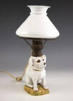 A table lamp, late 19th century/early 20th century, the base modelled as a porcelain dog, with glass