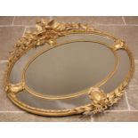 A 19th century giltwood and gesso oval wall mirror, surmounted with a pair of birds, quiver of