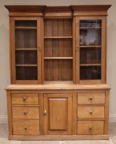 A Victorian satin walnut and pine kitchen dresser, the inverted breakfront top with open shelves