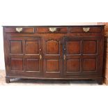 An 18th century oak dresser base, the twin plank moulded top over three lip moulded frieze drawers