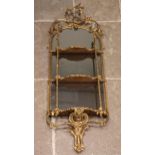 A 19th century giltwood and gesso mirrored wall shelf, the openwork interlaced foliate crest over an