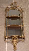 A 19th century giltwood and gesso mirrored wall shelf, the openwork interlaced foliate crest over an