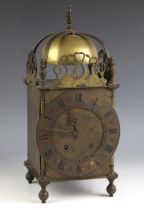 A Charles II style brass lantern form mantel clock, the 18cm dial applied with Roman numerals