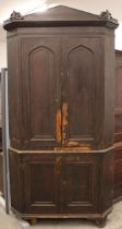 A 19th century scumbled pine freestanding corner cupboard, the architectural cornice over a pair