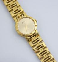 A ladies Piaget 18ct yellow gold wristwatch, the circular gold coloured dial with dotted markers,