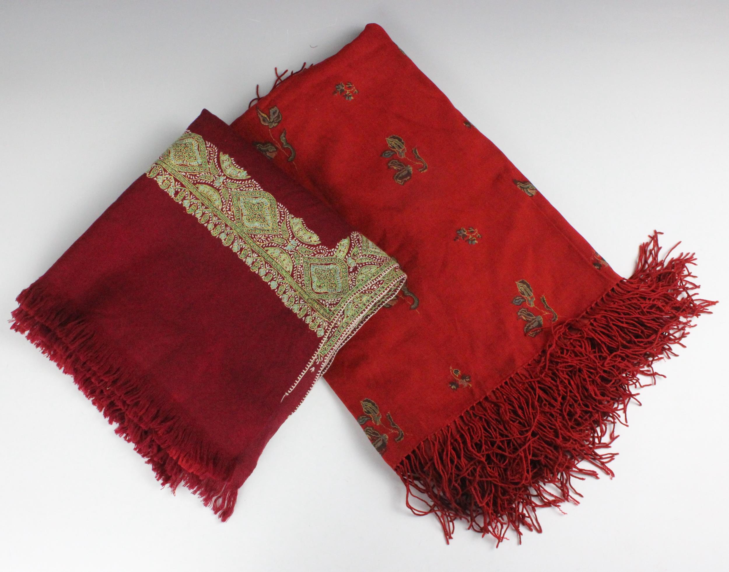 A mid Victorian crimson wool long shawl with embroidered borders of green and turquoise, with fringe