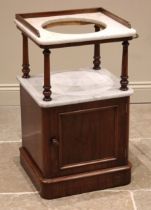 A Victorian mahogany and marble wash stand, the white marble top with a three quarter gallery and