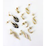 A group of five pairs of yellow metal and gold coloured earrings, including an openwork oval