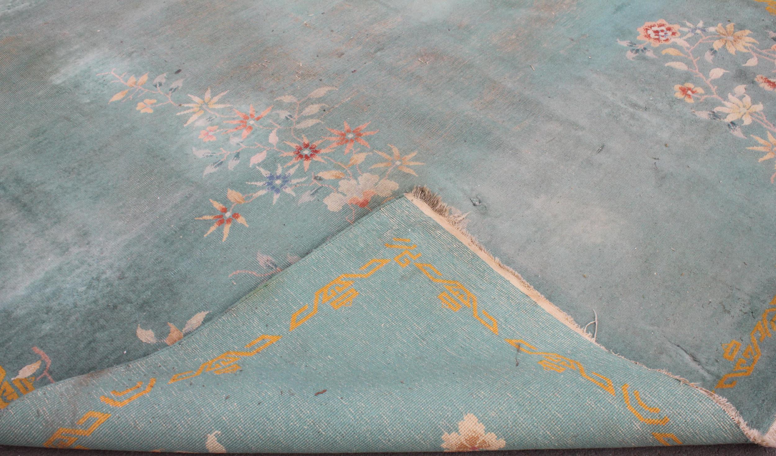 A large Chinese wool carpet, early 20th century, with floral motifs against a duck egg blue - Image 2 of 7