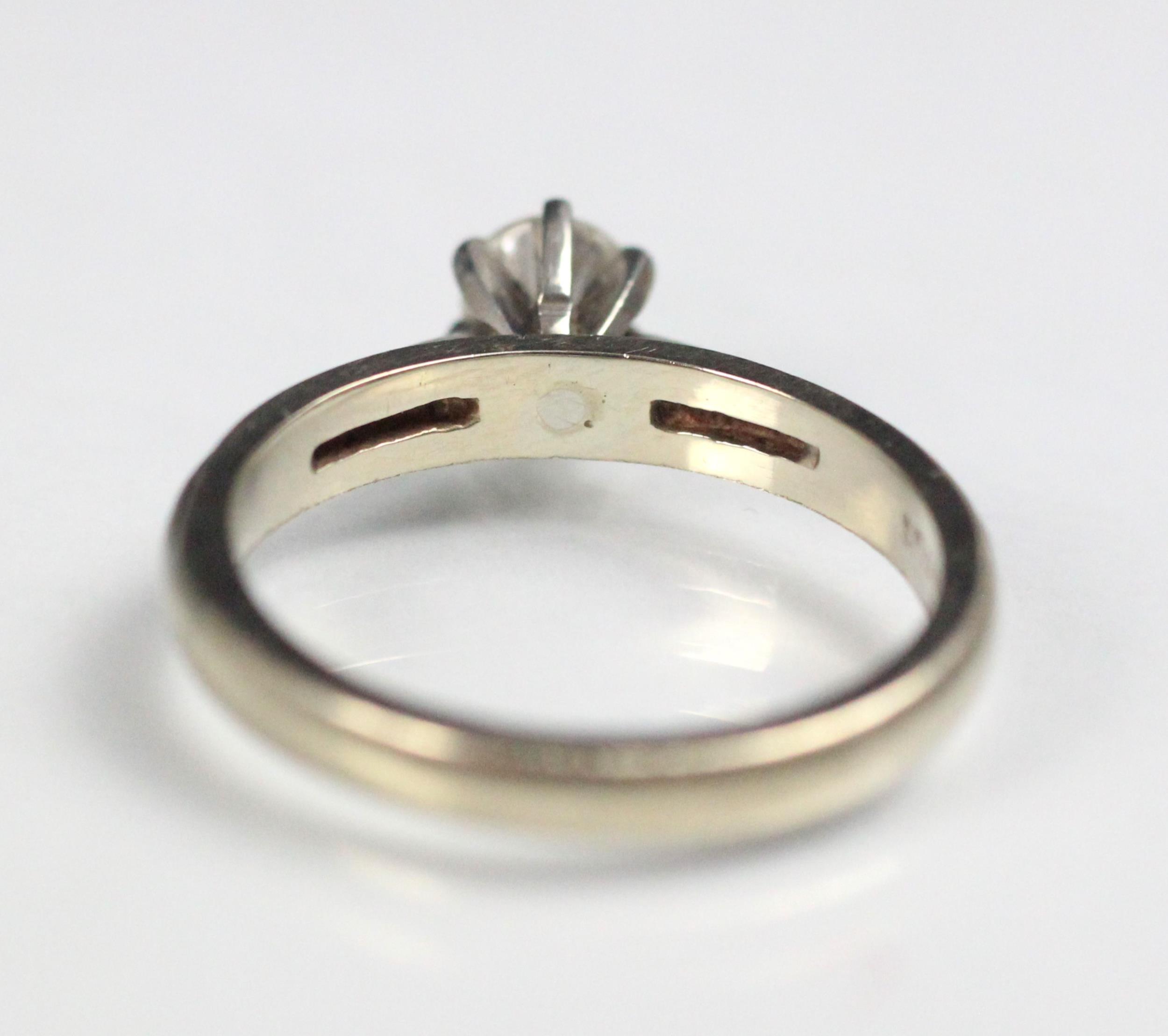 A certified diamond solitaire ring, the central round cut diamond claw set in raised mount, upon - Image 3 of 5