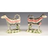 A pair of English Pottery pearlware cow creamers, circa 1810, with sponged decoration in pink and