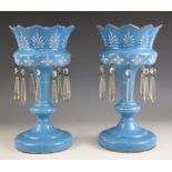 A pair of opaque blue glass lustres, late 19th century, painted white foliate decoration to the bow