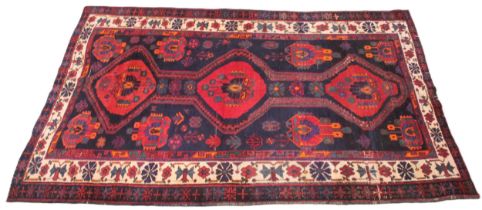 A vintage Persian Nahavan rug, bespoke design, rich colourways of blue, red orange and green, the