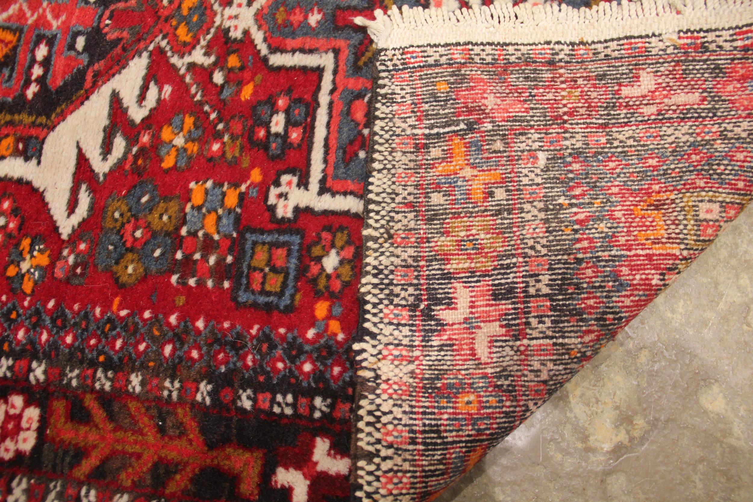 A North Iranian Persian Heriz runner, in red, blue and ivory colourways, the diamond medallion - Image 2 of 2