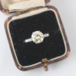 A mid 20th century diamond solitaire ring, the central round cut diamond with a trio of diamonds set