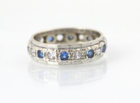 A 9ct white gold untested white sapphire and blue sapphire full eternity ring, the round cut blue