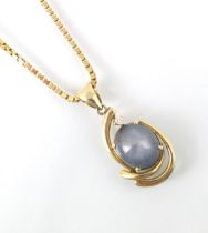 An untested star sapphire pendant, the cabochon stone within yellow metal mount with round cut