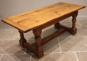 A 19th century pine refectory table, the cleated plank top upon ring turned baluster and block