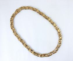 A 9ct yellow gold and diamond set necklace, the collar style necklace with stylised swirl links,