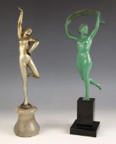 An Art Deco green patinated spelter figure modelled as a nude dancer, set to a tall stepped polished