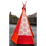 A folding teepee, the five tubular alloy supports covered in vibrant red and orange fabric, pole