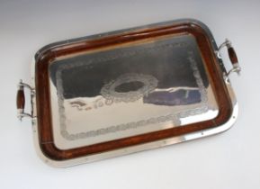 A 20th century silver plated and oak tray, the twin barrel shaped handles above an ivy engraved