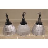 Three Simplex aluminum industrial light shades, mid 20th century, of typical domed form, below a