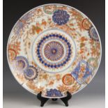 A large Japanese porcelain Imari charger, Meiji Period (1868-1912), the circular charger decorated