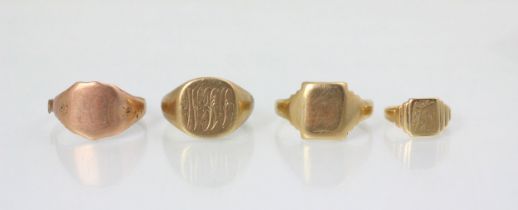 A group of four yellow metal signet rings, including two examples with engraved monogram to head,