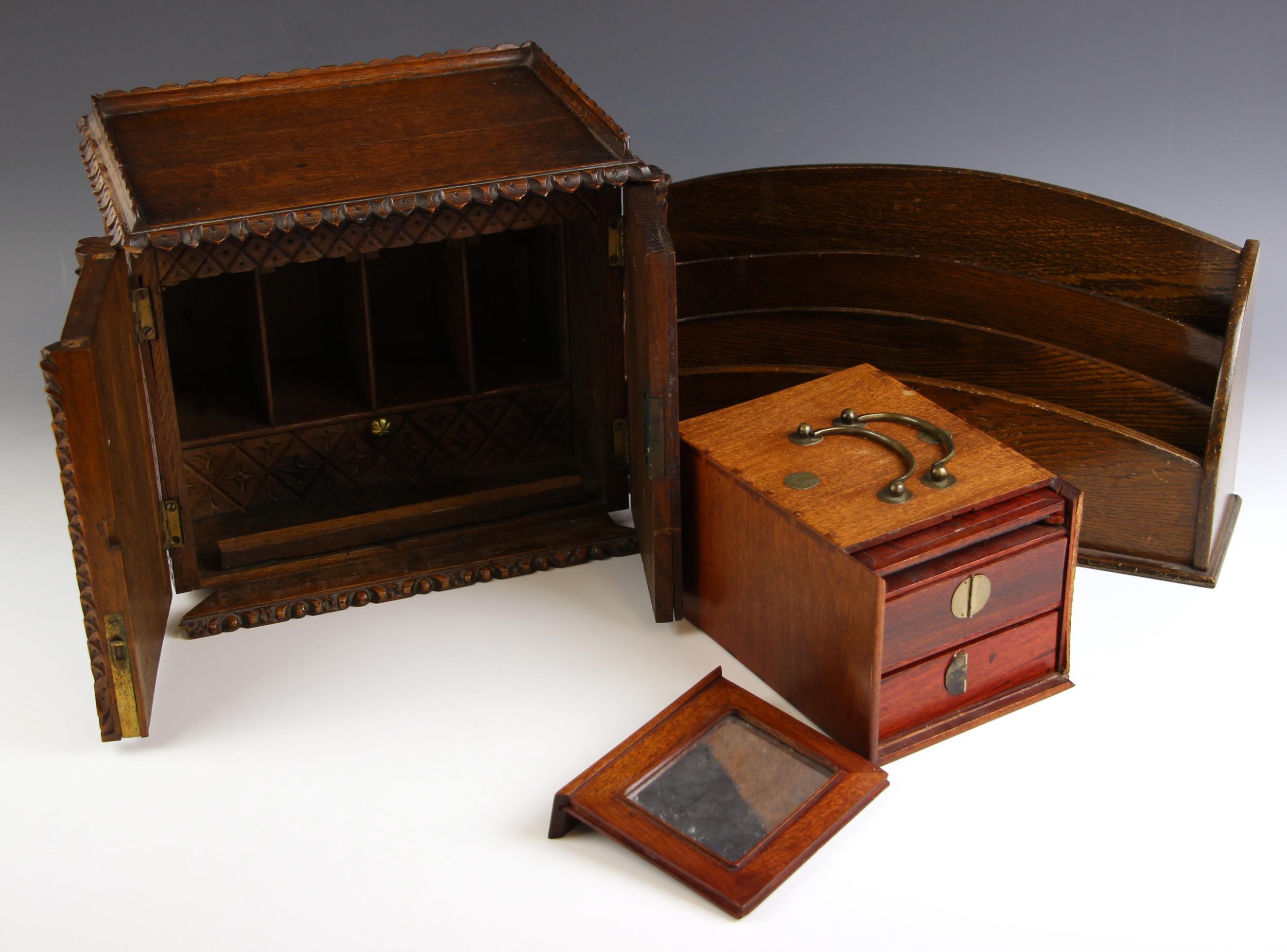 A Victorian carved oak stationery cabinet, the two doors opening to a compartmented interior with - Image 2 of 2